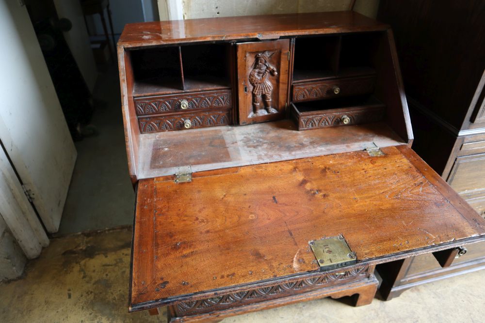 A small 18th century walnut bureau, later carved, width 76cm depth 47cm height 103cm